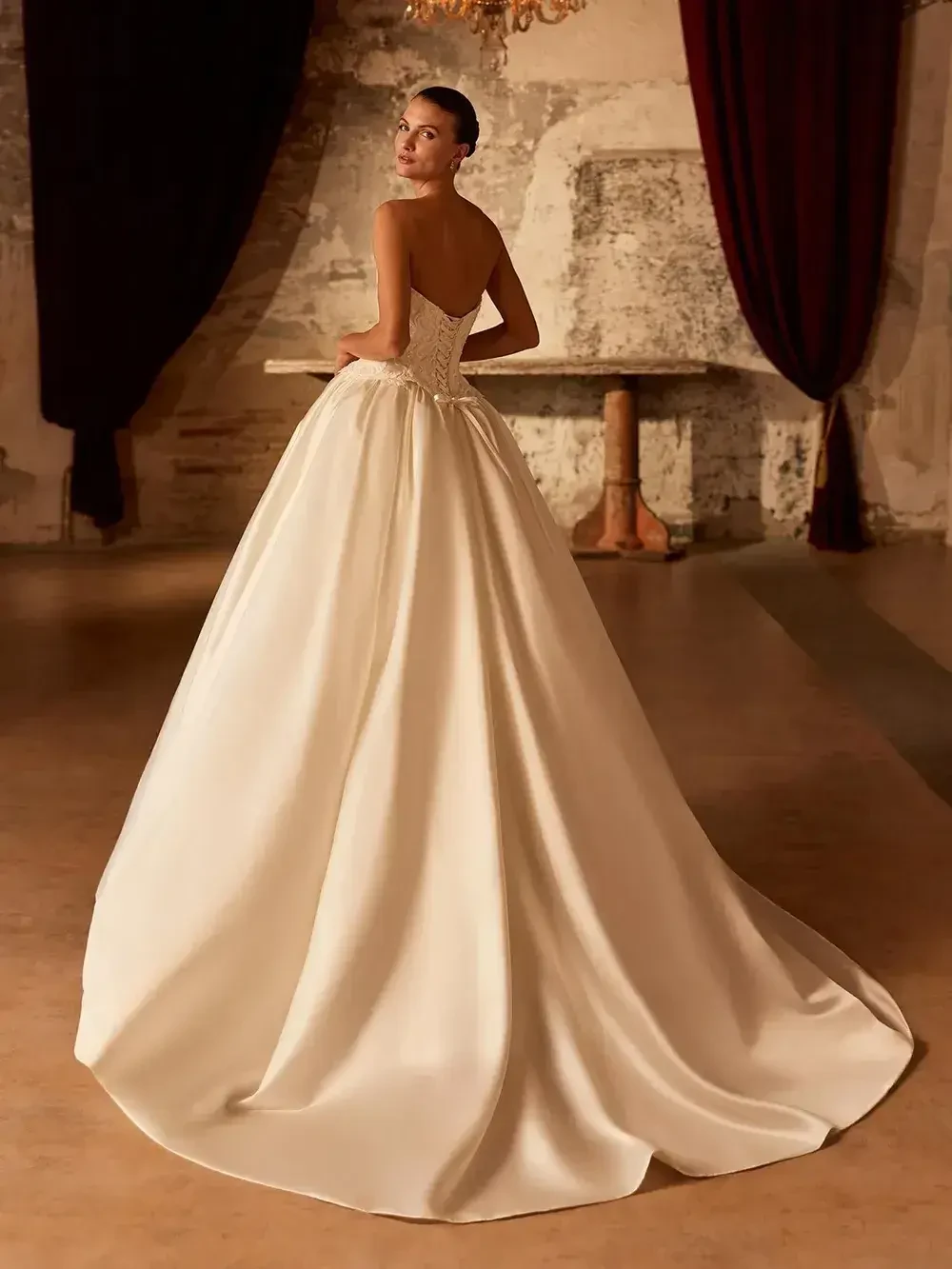 model is wearing a strapless ball gown wedding dress