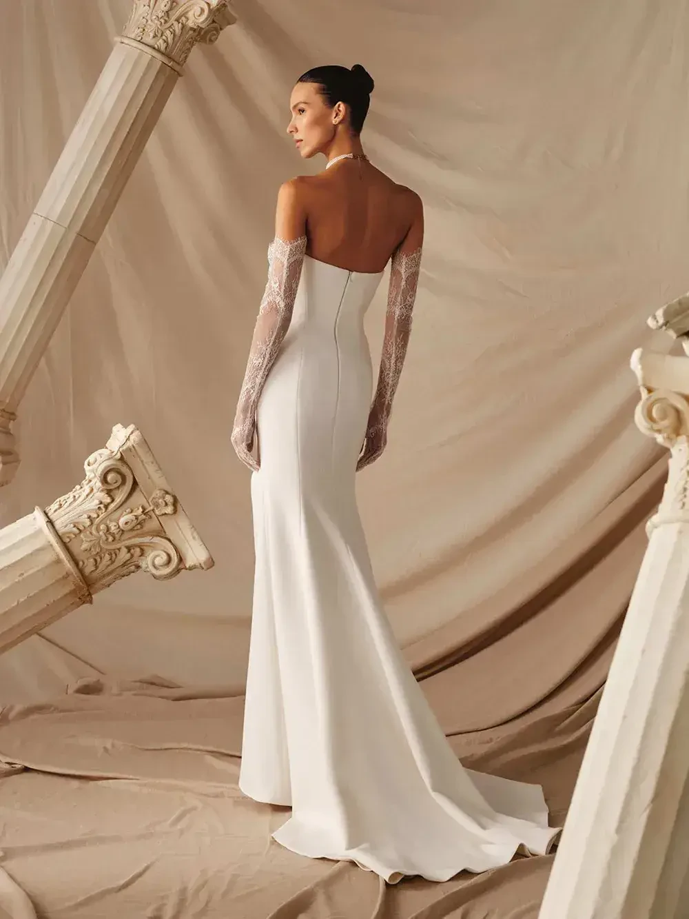 model is wearing a strapless fitted bridal gown