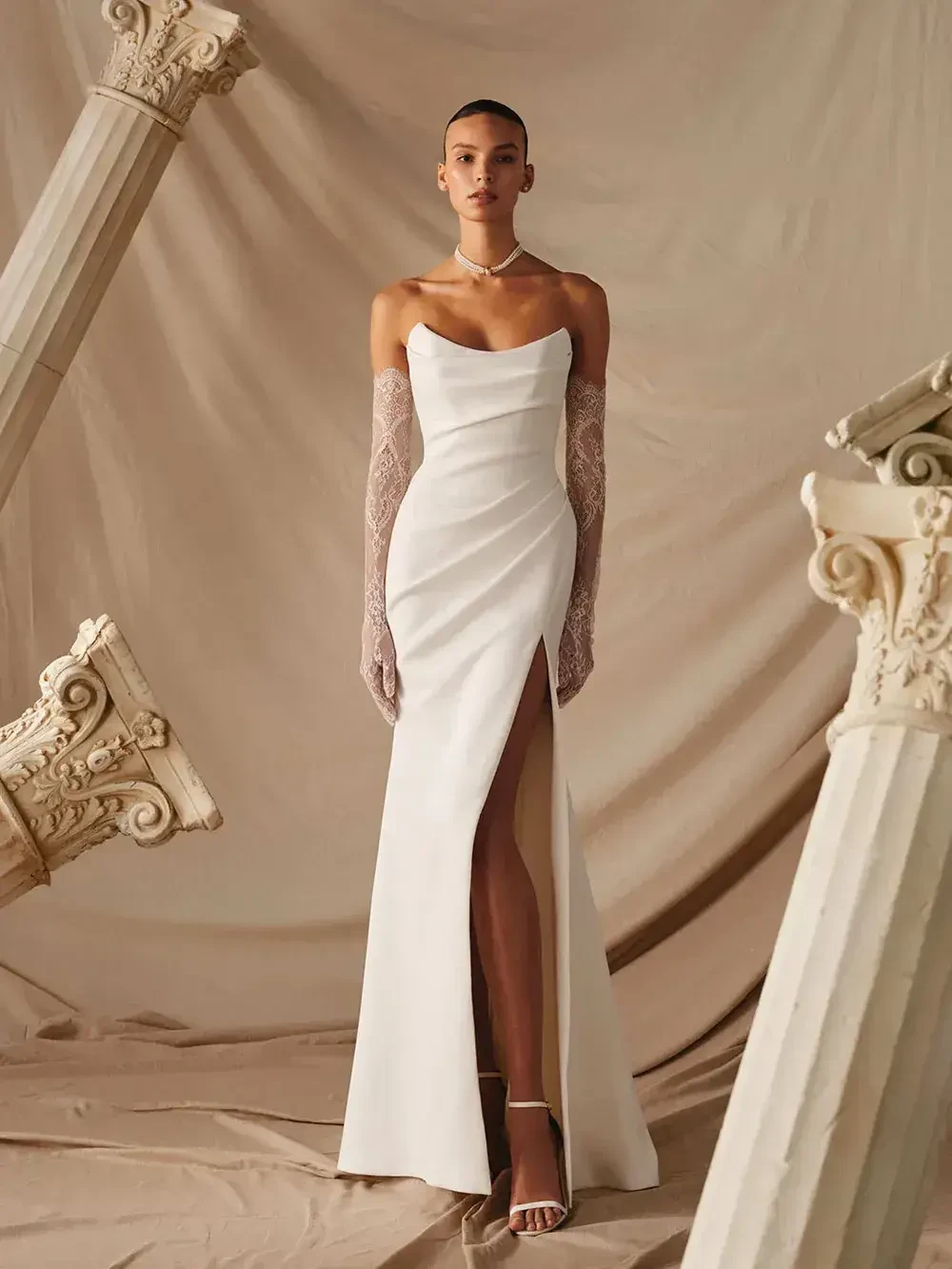 model is wearing a strapless fitted bridal gown